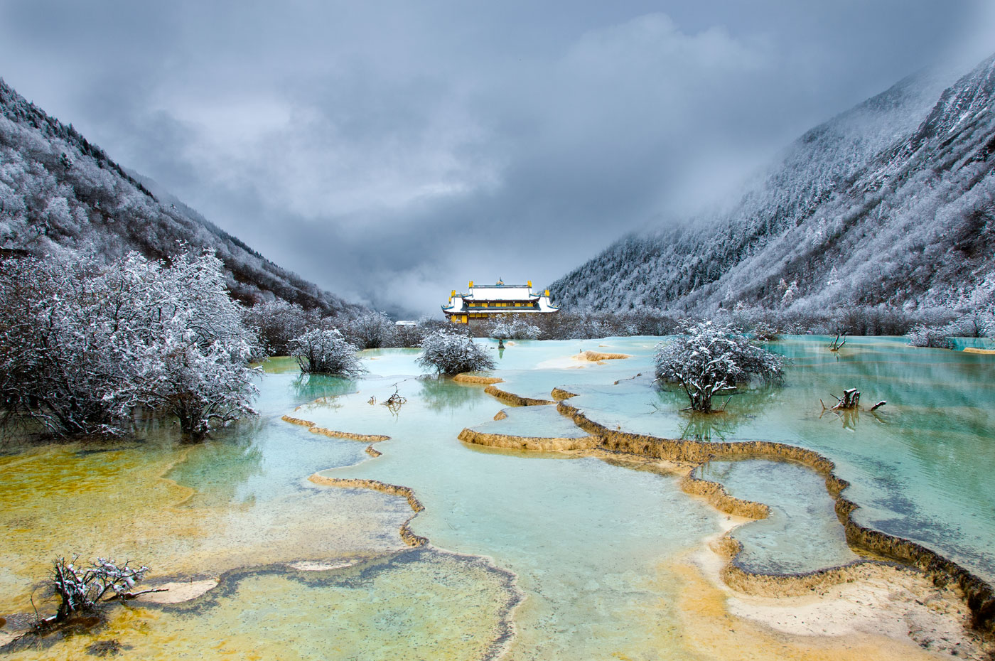 No. 14: Marvel at the multicolored ponds of Huanglong NP when the first snow turns the place into a fairy-tale atmosphere - Huanglong NP, Tibetan China, 2010